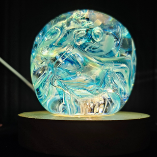 Colorful glass-blown orb-shaped nightlight on LED light base